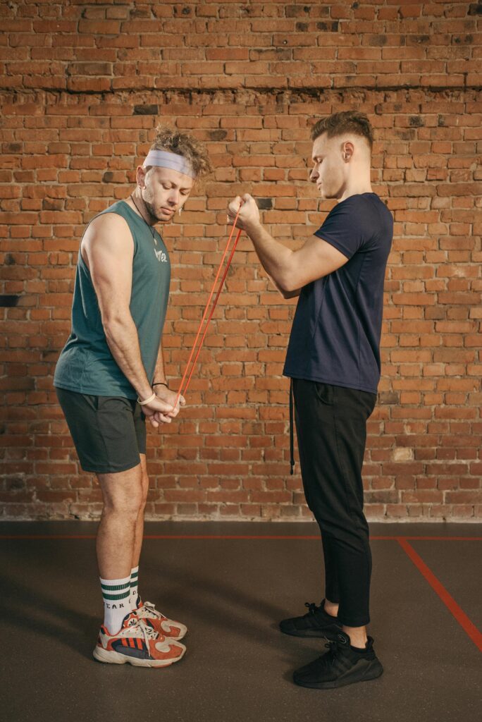 Man demonstrating how to train with resistance bands for a triceps workout