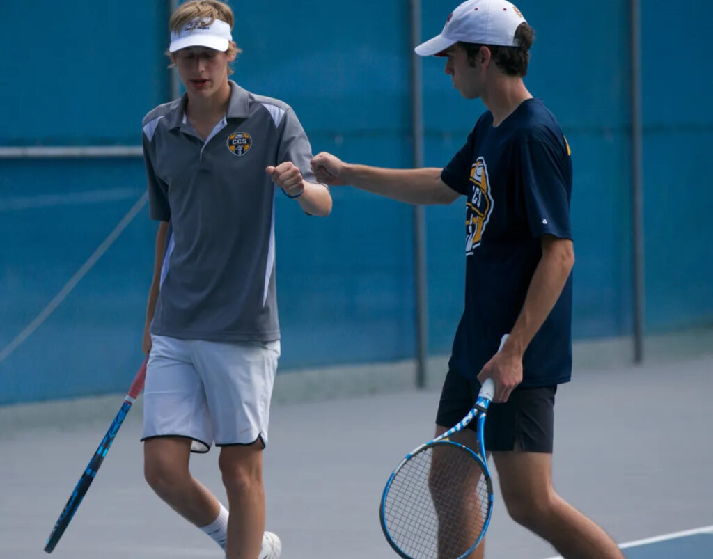 two tennis players celebrating after a point