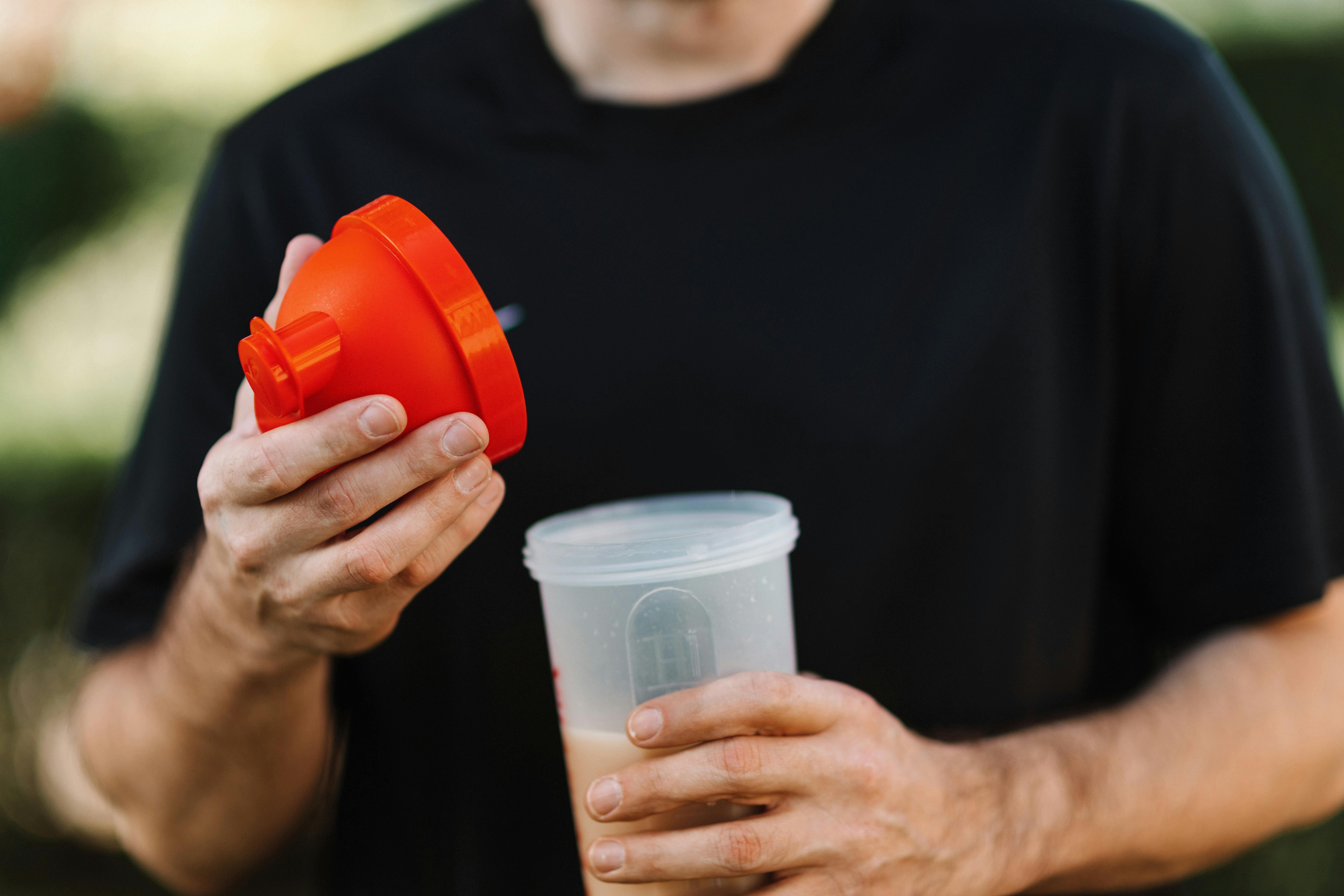 guy eating a protein shake as a pre workout snack for muscle gain